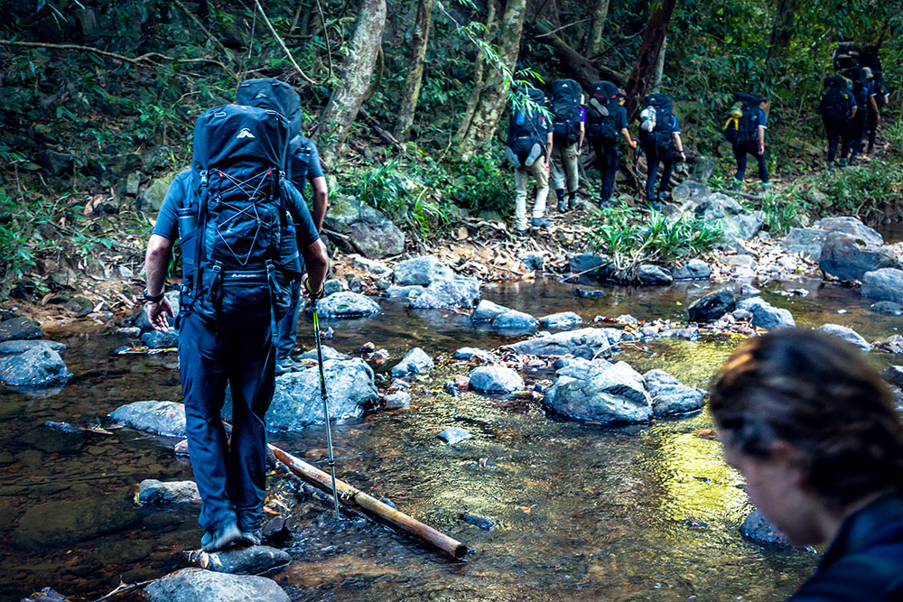 Students crosing a river in Cambodia - Escape Adventurous Journeys School trips