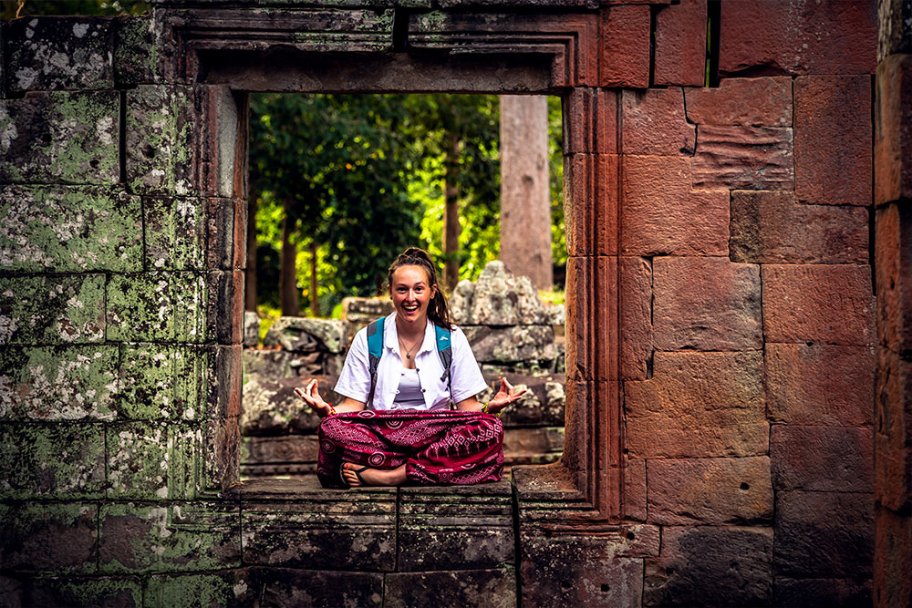 Girl sitting in ruin - Cambodia SChool TRips NZ