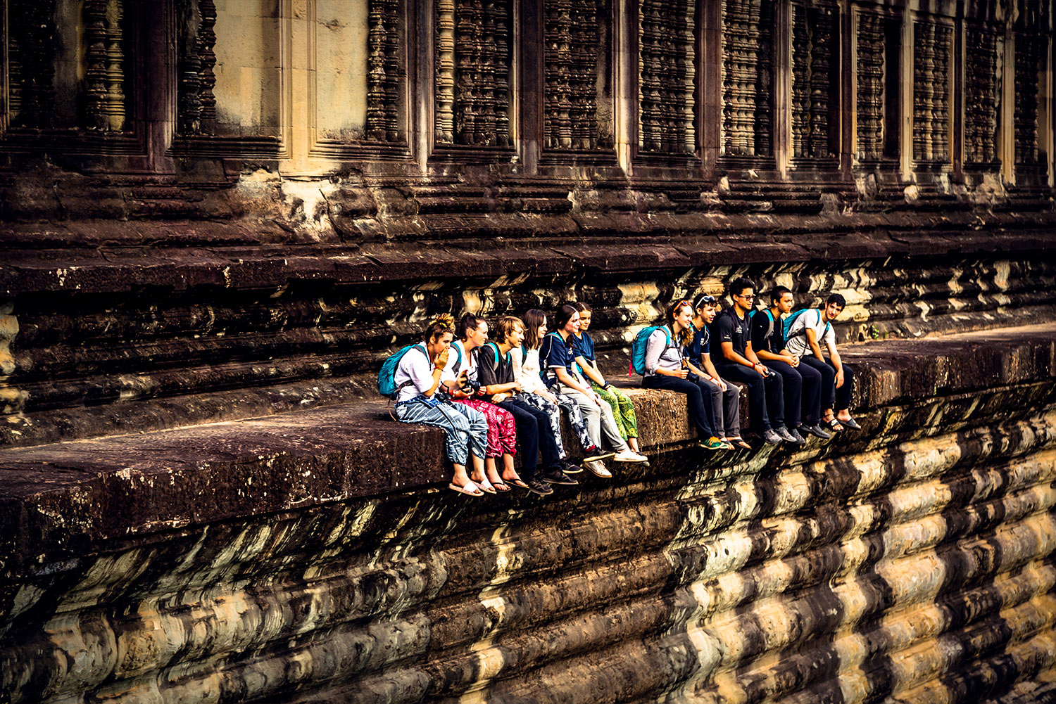 Cambodia school trip -students sitting on a ruin in Cambodia